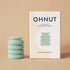 Product shot of the Ohnut device displayed alongside its packaging, showcasing the product and its branding.